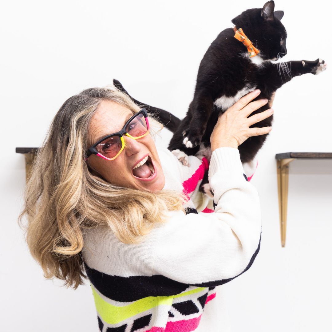 Womens holds cat while wearing The Italo Clawdia with a photochromic rose lens from Pit Viper