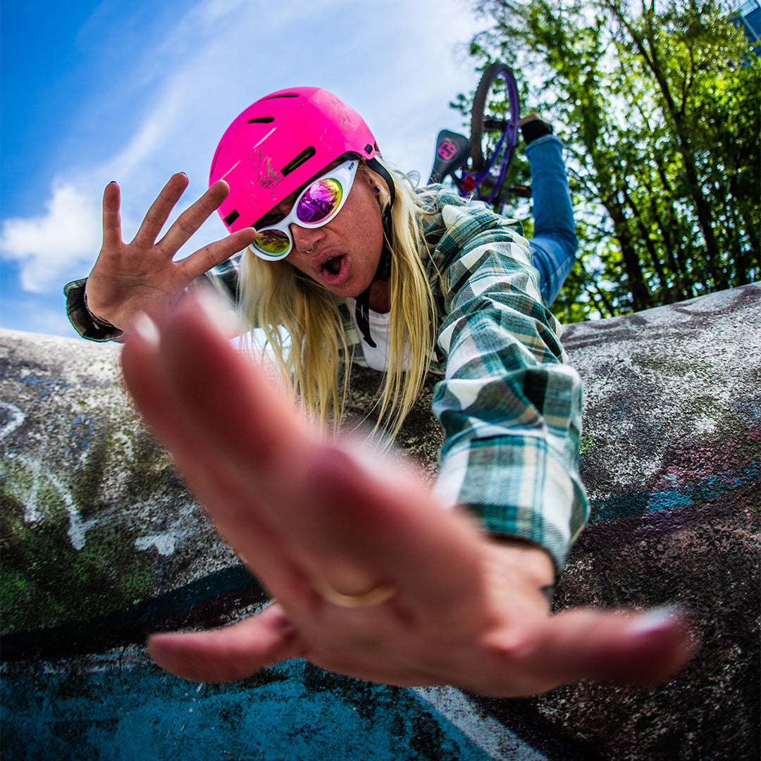 Woman falling off bike wearing Pit Viper Sunglasses